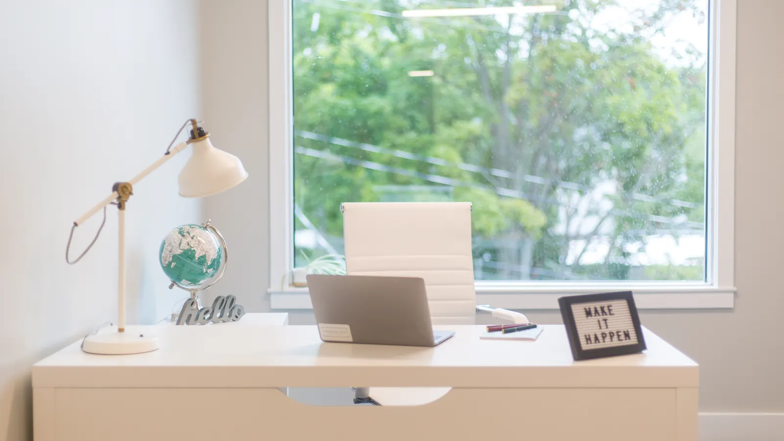 Laptop on a desk in a bright home office