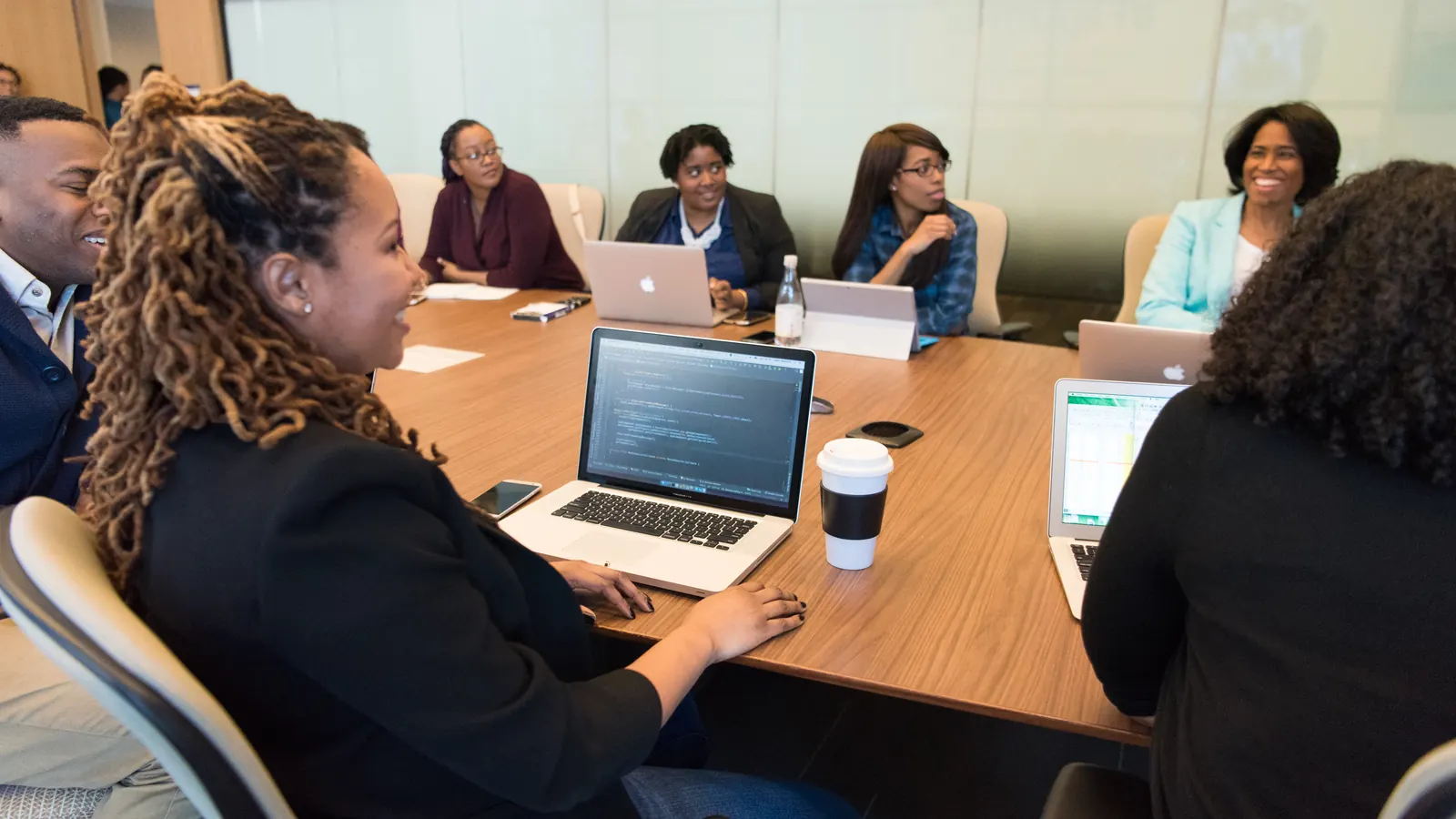 Team working on laptops around a meeting table
