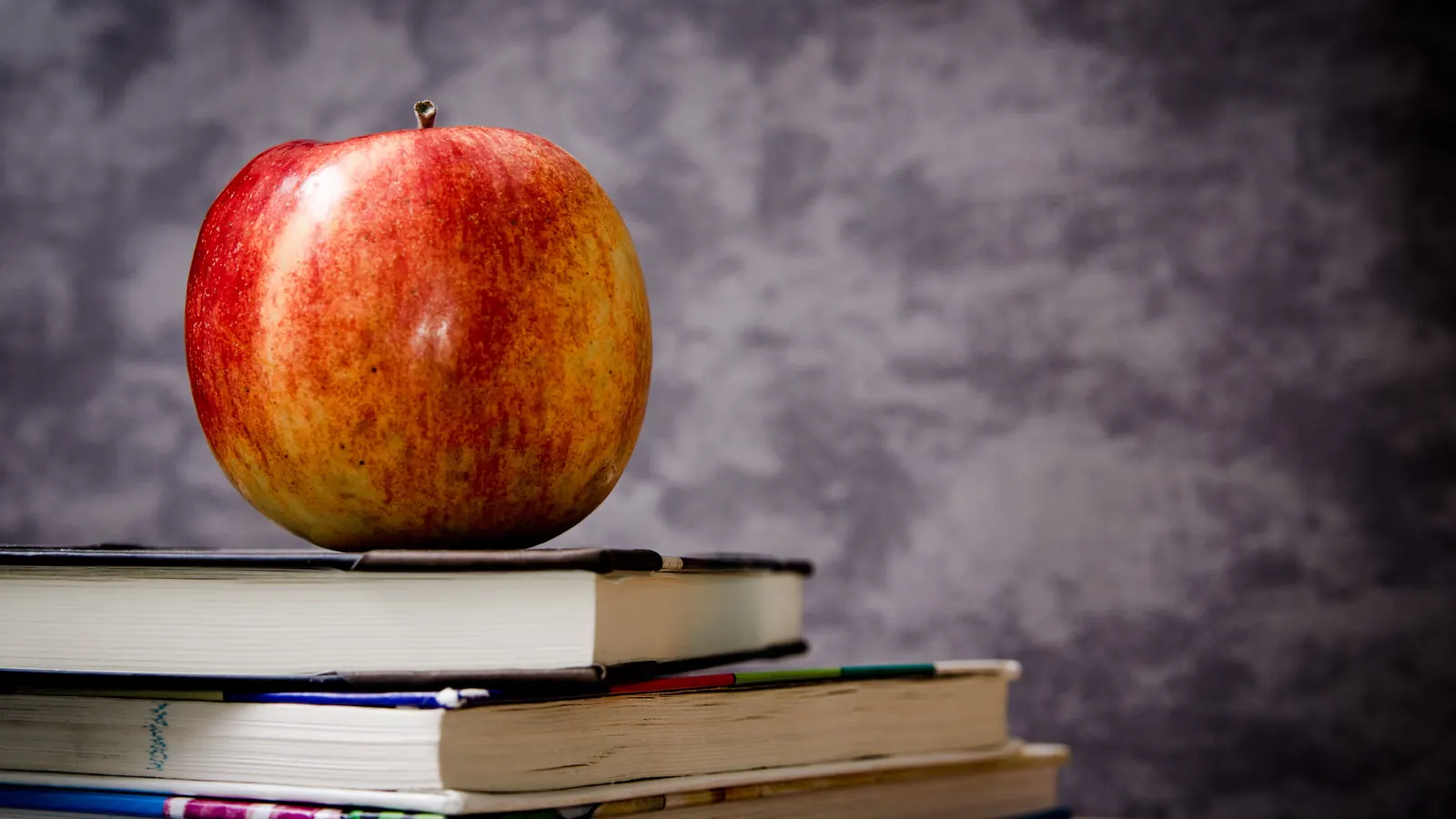 Red apple on a stack of books