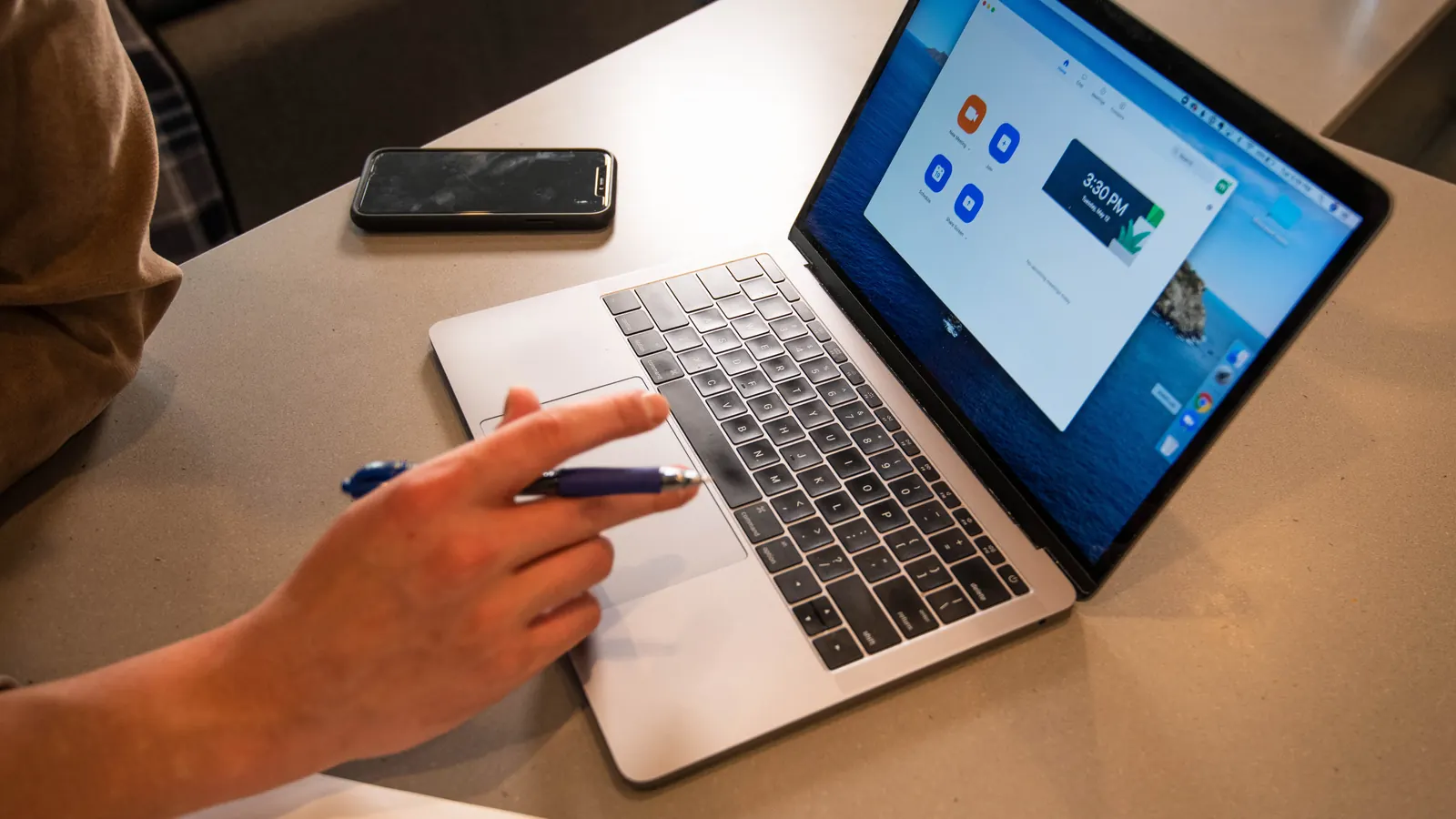 Person working on a laptop at a desk
