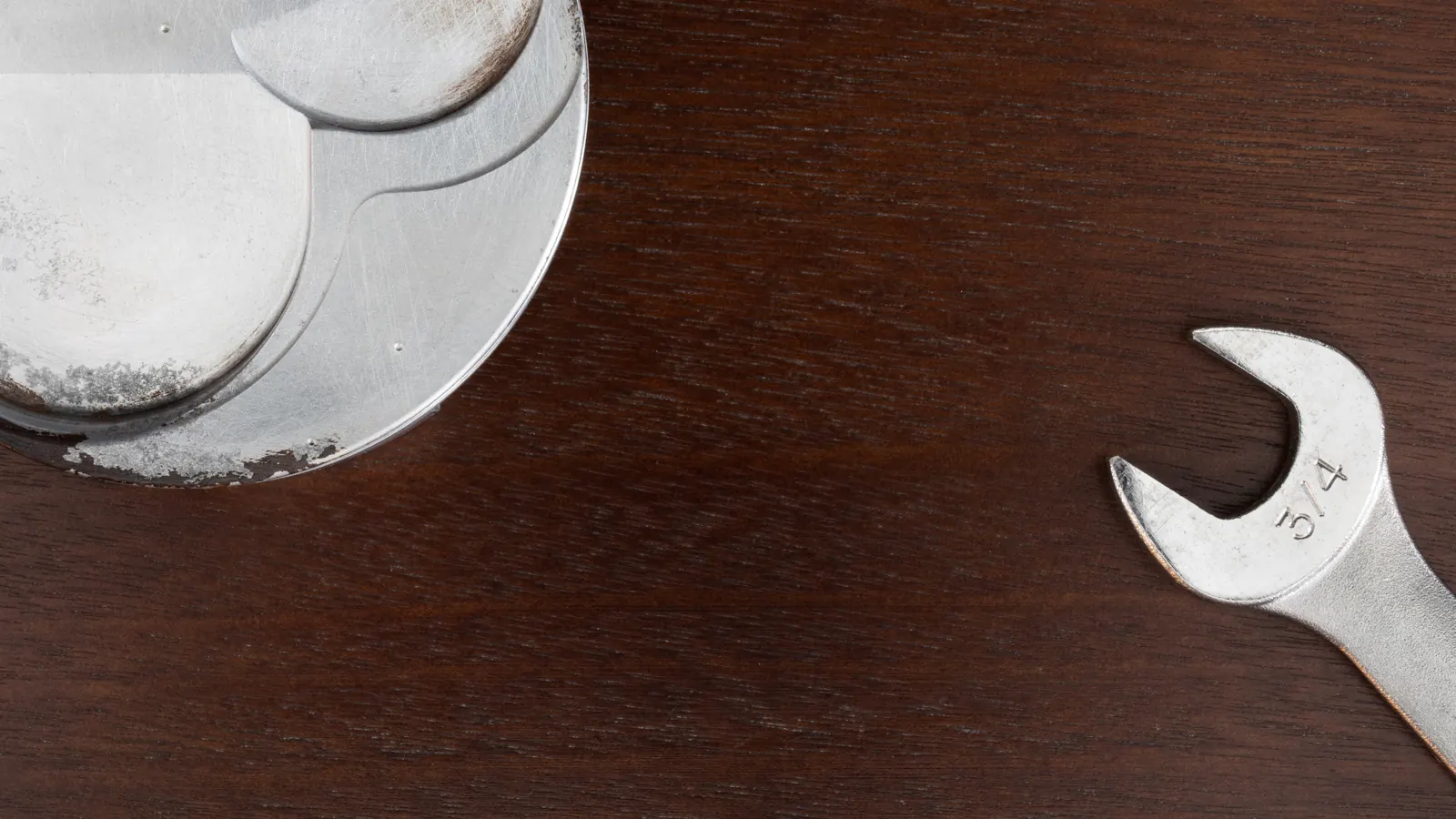 Wrench lying on a wooden workbench