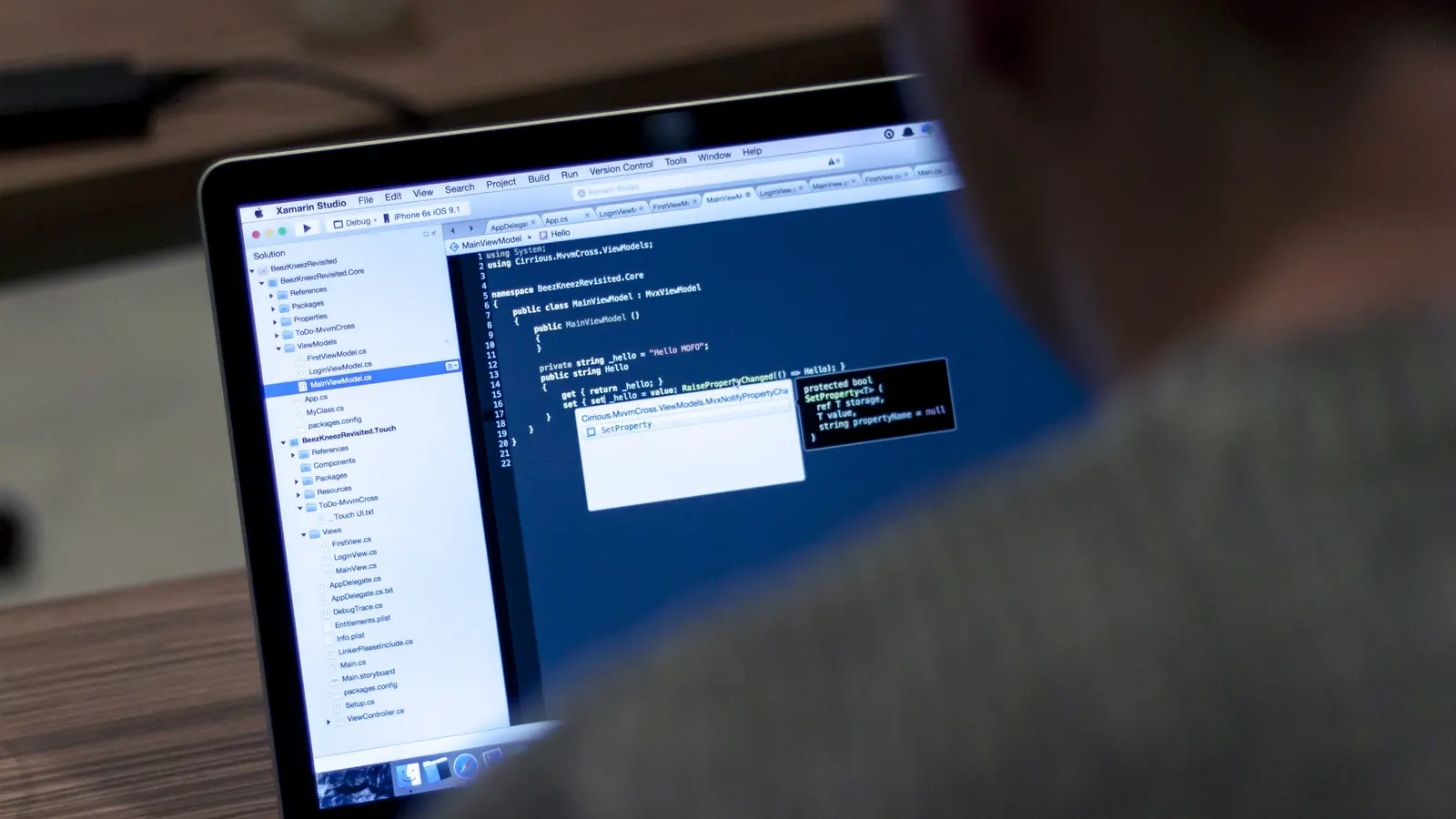 Developer working on code on a laptop