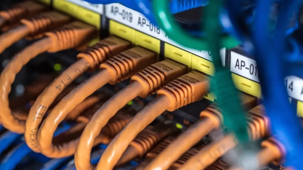 Labelled network patch panel with orange cables