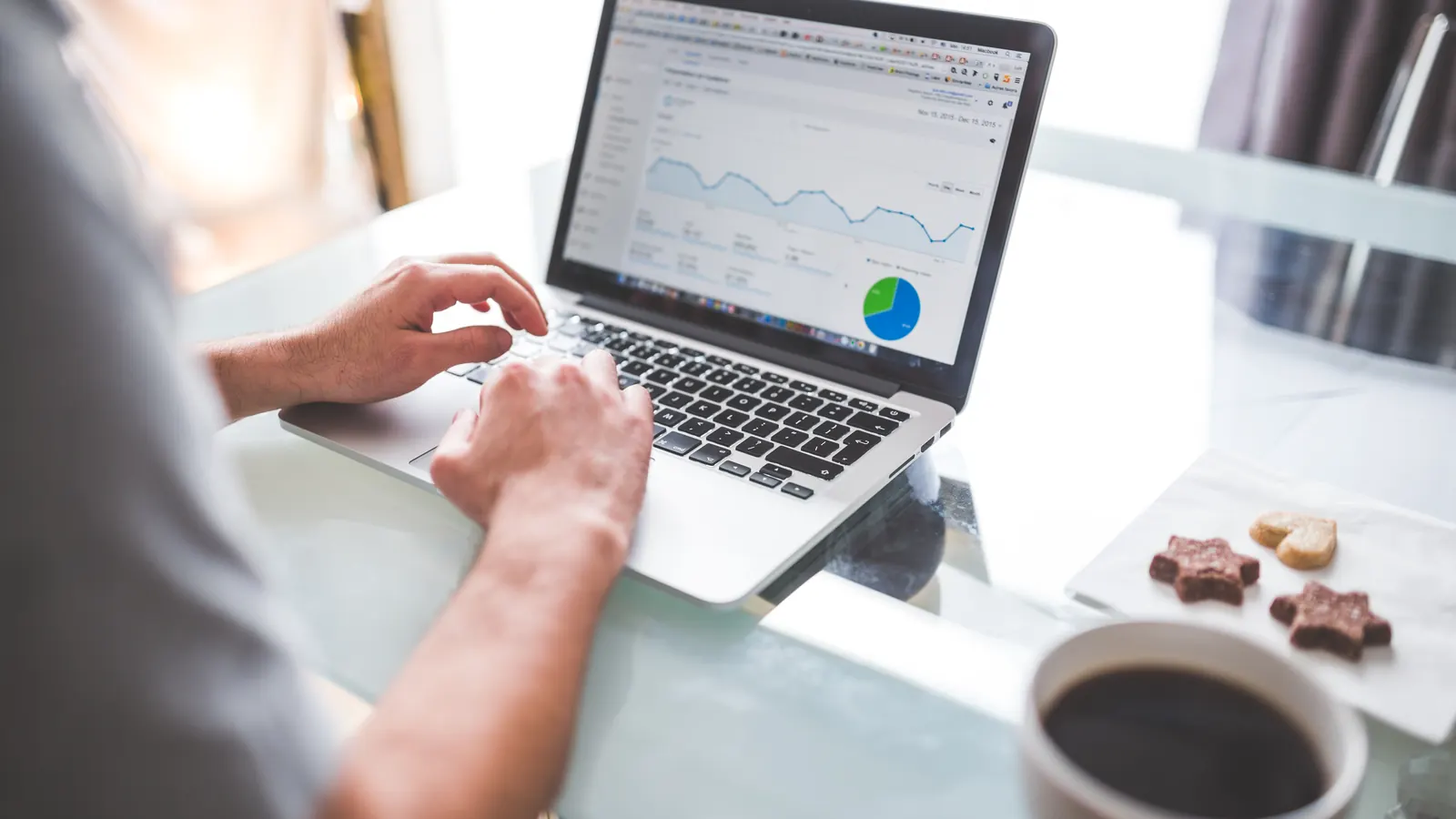 Person using a laptop showing analytics charts