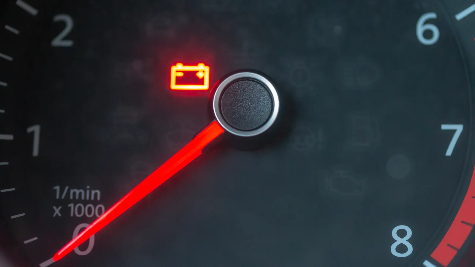 Car dashboard tachometer with a red needle