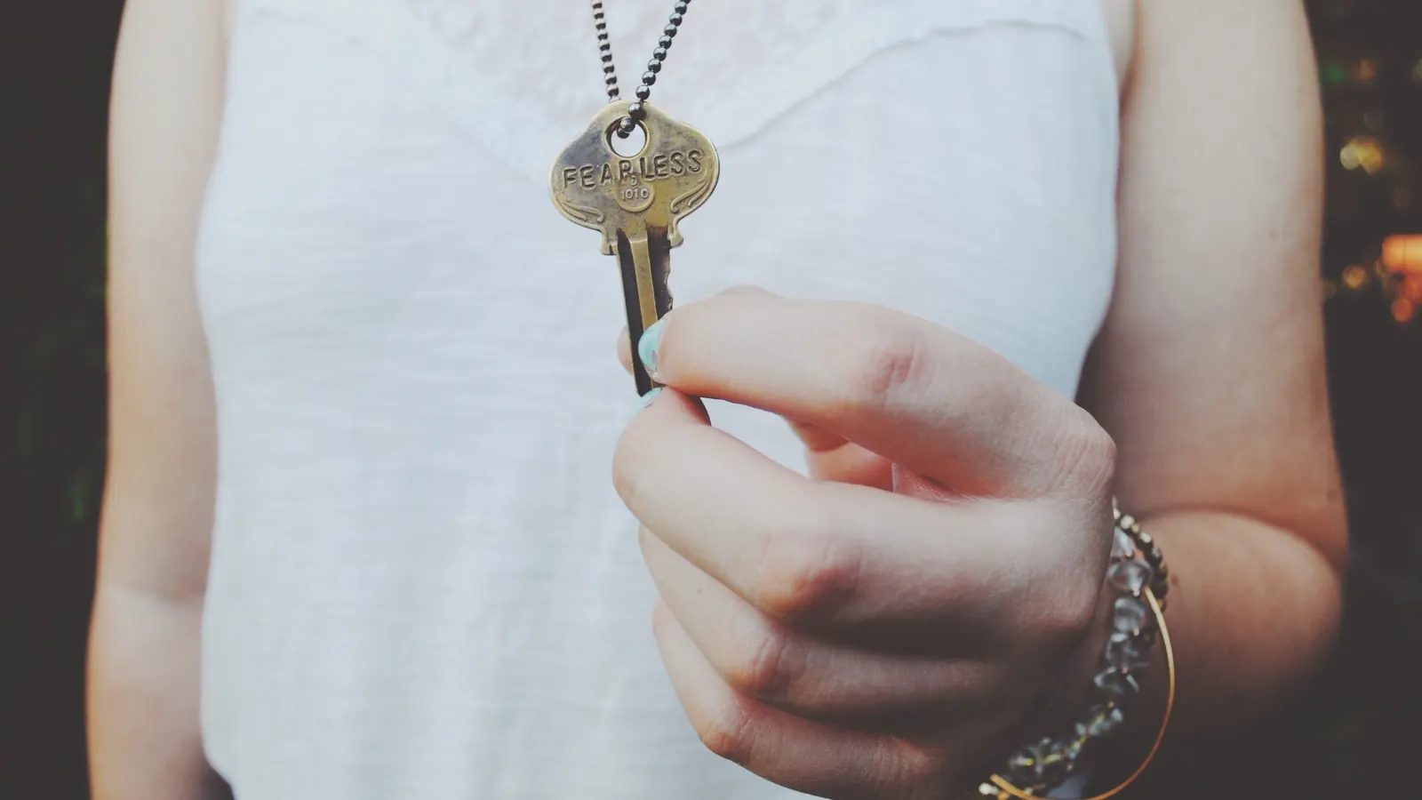 Person holding a key on a chain