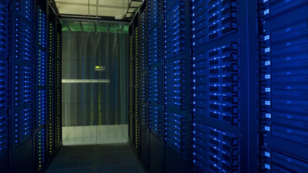 Blue-lit server racks in a dark data centre